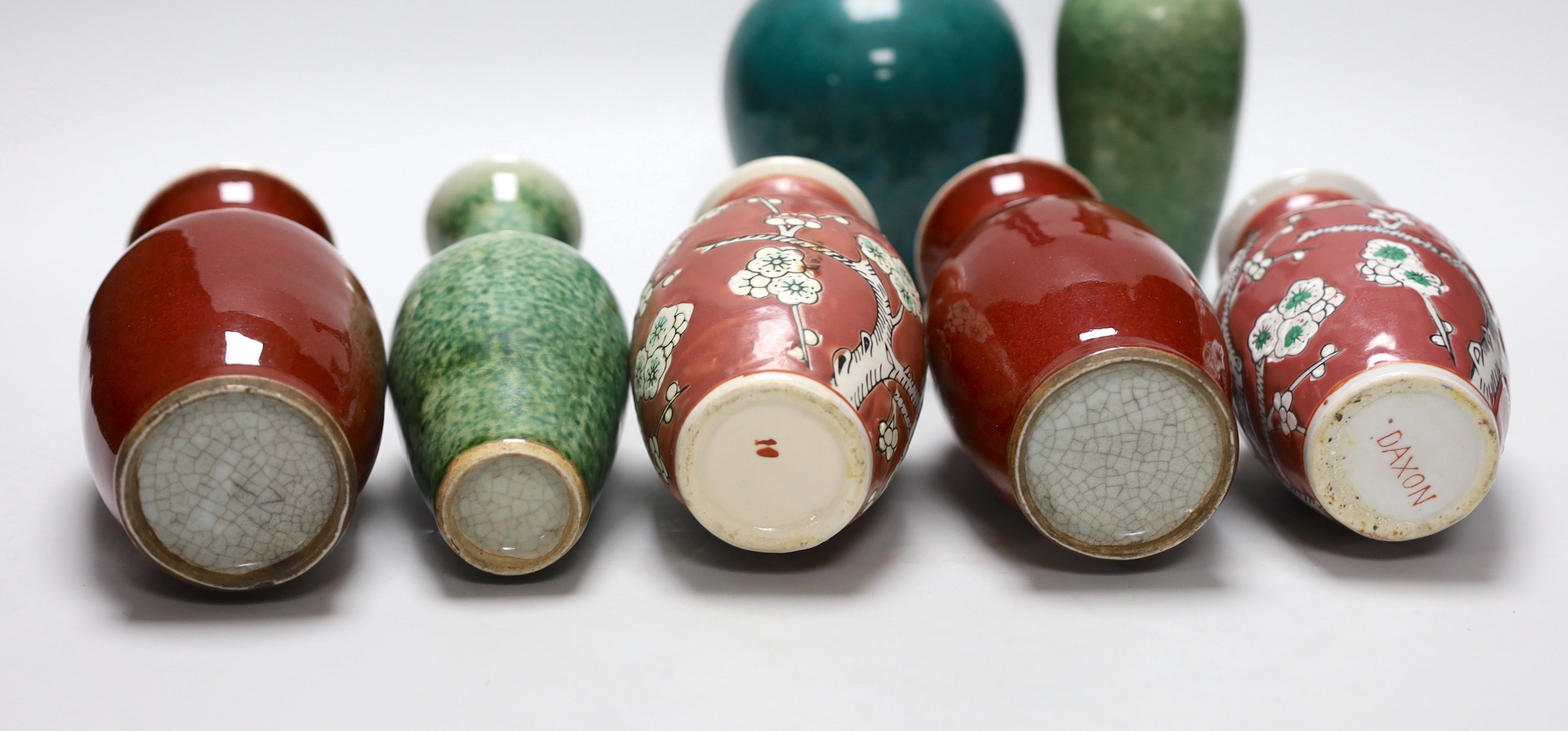 A pair of Chinese sang de boeuf vases, another pair of Chinese mottled green bottles vases, two pink ground prunus vases and a turquoise glaze bottle vase, tallest 23cm (7)